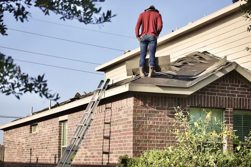 Professional roofer working on a residential roof in Fountainhead